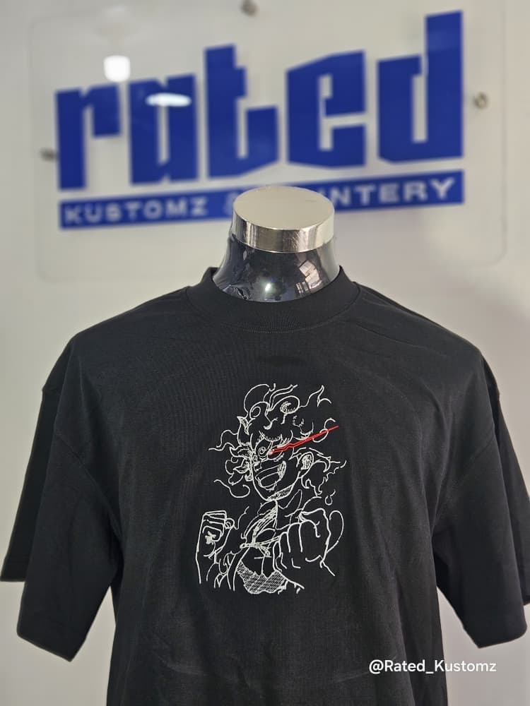 Embroidery Graphic Tee — Fine-detail embroidered artwork on oversized black tee
